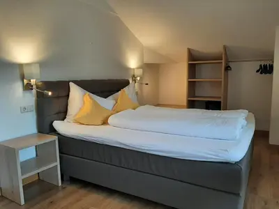a large bed with yellow pillows in a room at Residence Adler in Tesimo