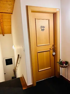 a door in a hallway with a sign on it at Stanza Roma in Tesero