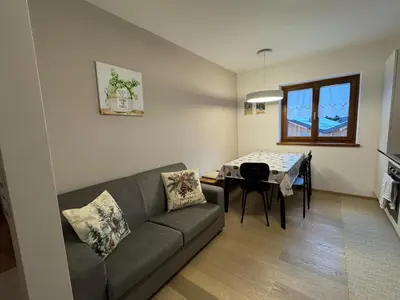 a living room with a couch and a table at Ciasa Enrico in Arabba