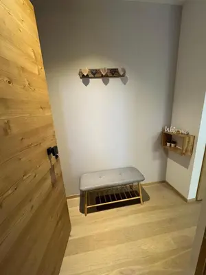 a room with a bench in the corner of a room at Ciasa Enrico in Arabba
