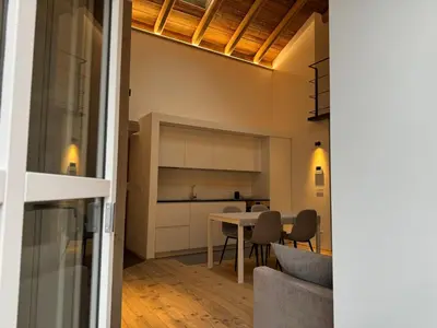 a kitchen and dining room with a table and chairs at Alpen Chic in Cavalese