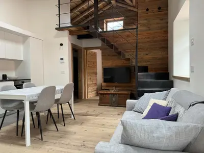 a living room with a couch and a table at Alpen Chic in Cavalese