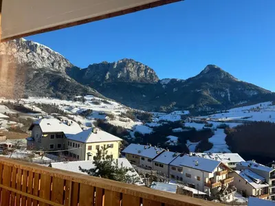 a view from the balcony of a resort with snow covered mountains at Apartements Mitterstill in Fiè