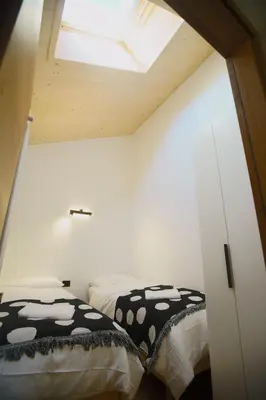 a bedroom with two beds and a window at A93A Apartment Alicia in Carano