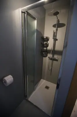 a shower with a glass door in a bathroom at A93A Apartment Alicia in Carano