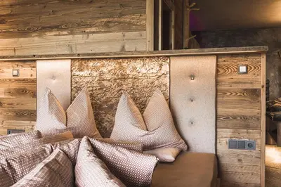 a wall with a bunch of pillows on it at Kirchwies Naturchalet - Adults Only in Laion