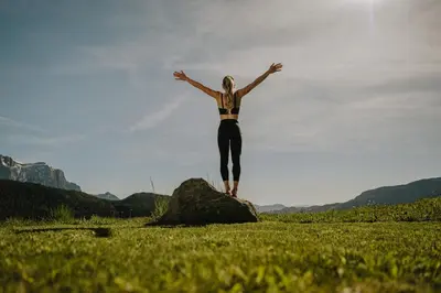 a woman standing on a rock in a field at Kirchwies Naturchalet - Adults Only in Laion