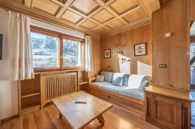 a living room with a couch and a table at Casa Ronco, tranquilla e confortevole in Cortina dʼAmpezzo