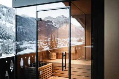 a room with a glass door with a mountain view at DISTINCTIVE LUXURY DOLOMITI Apartments TERRE71 in San Vigilio Di Marebbe