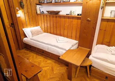 a small room with a bed and a table at HT - Ciasa Ca'Mora nel centro di Cortina d'Ampezzo in Cortina dʼAmpezzo