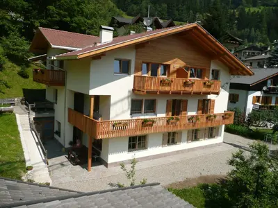 a large house with a balcony on the side of it at Haus Grünfeld in Santa Valburga St. Walburg