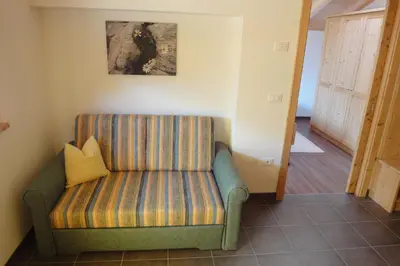 a couch in a room with a picture on the wall at Haus Grünfeld in Santa Valburga St. Walburg