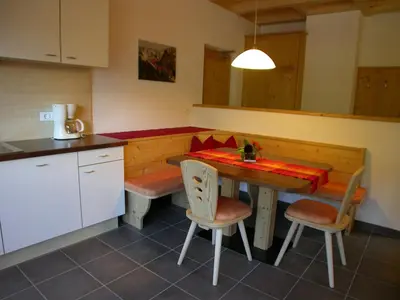 a kitchen with a table and chairs in a kitchen at Haus Grünfeld in Santa Valburga St. Walburg