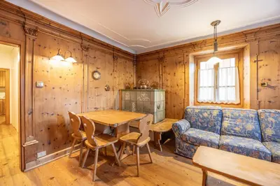 a living room with a table and a couch at Casa Zardini, in centro a Cortina d'Ampezzo in Cortina dʼAmpezzo