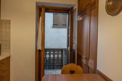 a kitchen with a wooden table and a window at Casa Zardini, in centro a Cortina d'Ampezzo in Cortina dʼAmpezzo