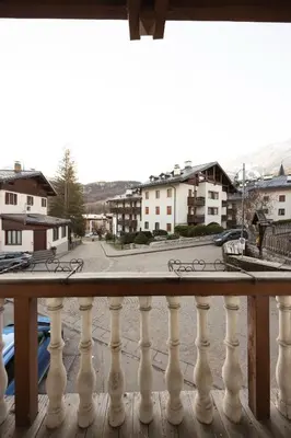 a balcony with a view of a street and buildings at Casa Zardini, in centro a Cortina d'Ampezzo in Cortina dʼAmpezzo