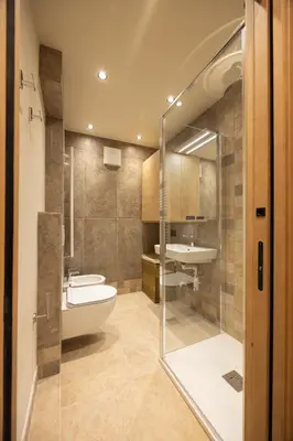 a bathroom with a tub and a toilet and a sink at Casa Zardini, in centro a Cortina d'Ampezzo in Cortina dʼAmpezzo
