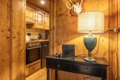 a lamp sitting on a table in a kitchen at Chiara Home, in centro a Cortina d Ampezzo in Cortina dʼAmpezzo
