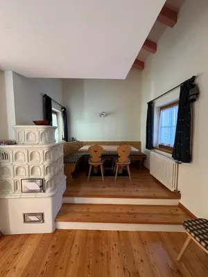 a living room with a table and two chairs at Cèsa Emily in Campitello di Fassa
