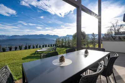 a table and chairs with a view of the mountains at HOMESTWENTY3 - Home six in Caldaro