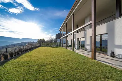 a building with a large grass field next to it at HOMESTWENTY3 - Home six in Caldaro