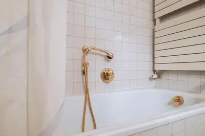 a bathroom with a shower with a tub at GuestHost - Cortina Heart Retreat with Parking in Cortina dʼAmpezzo