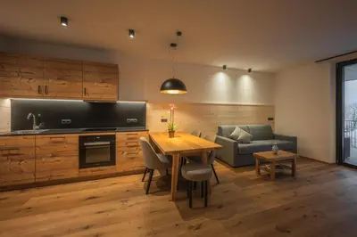 a living room with a table and a couch at A-Lunis in Brunico