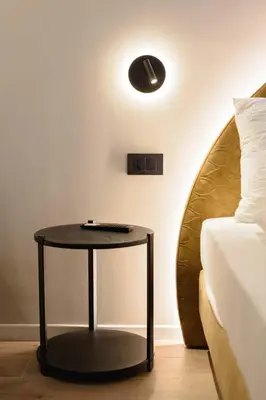 a black table in a room with a bed at NAOMI Rooms in Salorno sulla Strada del Vino