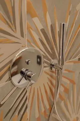 a shower head with a mirror on a wall at NAOMI Rooms in Salorno sulla Strada del Vino