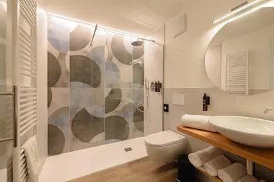 a bathroom with a sink and a toilet and a shower at NAOMI Rooms in Salorno sulla Strada del Vino