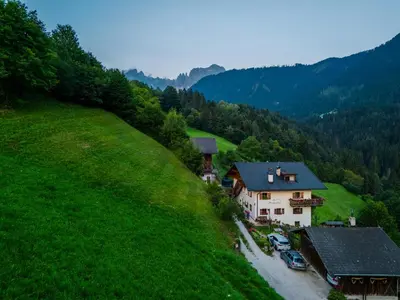 a house on the side of a green hill at Spinuserhof in Tires