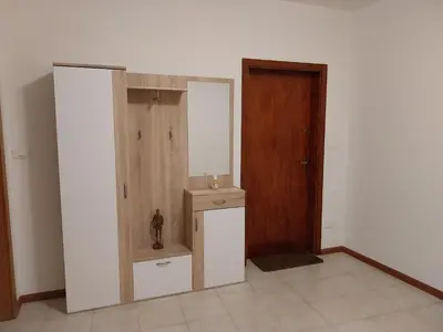 a room with a door and a room with a small cabinet at Appartamento vacanze Tres - Predaia in Tres