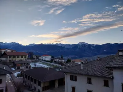a view of a town with mountains in the background at Appartamento vacanze Tres - Predaia in Tres