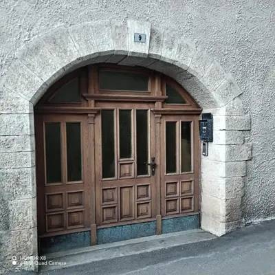 a large wooden door in a stone building at Appartamento vacanze Tres - Predaia in Tres