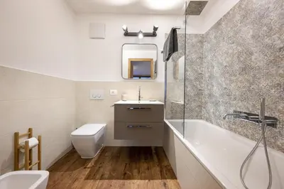 a bathroom with a tub and a sink and a toilet at Apartments No7 Sella in Ortisei