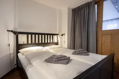 a bedroom with a large bed with towels on it at Apartments No7 Sella in Ortisei