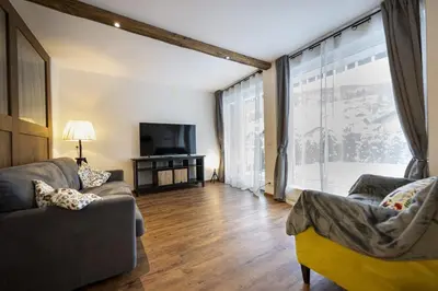 a living room with two couches and a large window at Apartments No7 Sella in Ortisei