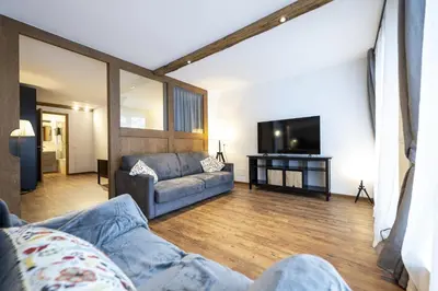 a living room with a couch and a tv at Apartments No7 Sella in Ortisei