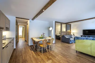a kitchen and living room with a table and chairs at Apartments No7 Sella in Ortisei