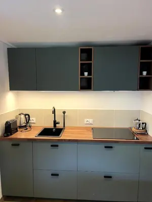 a kitchen with white cabinets and a sink at Casa Sasso Bianco in Rocca Pietore