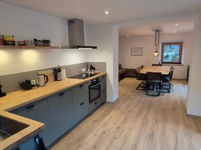 a kitchen and dining room with a table and a dining room at Casa Sasso Bianco in Rocca Pietore