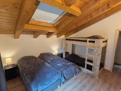 a bedroom with a bunk bed and a ladder at Casa Sasso Bianco in Rocca Pietore