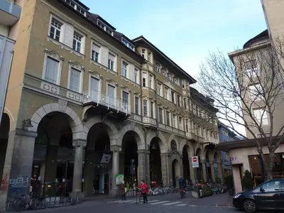 a large building on a city street with bikes parked outside at Apartment Leonardo in Bolzano