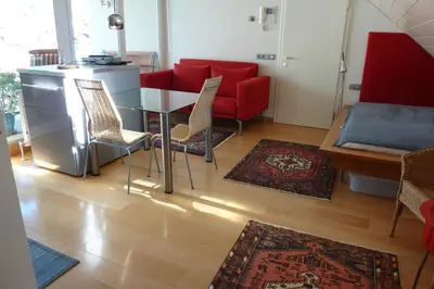 a living room with a table and chairs and a couch at Apartment Leonardo in Bolzano