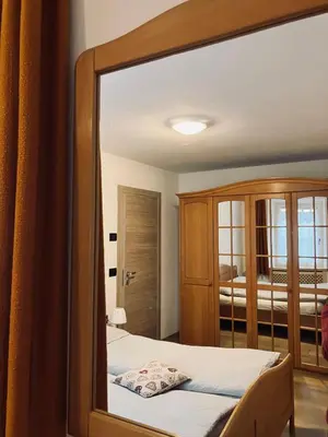 a mirror reflection of a bedroom with a bed at CERMIS Minisuite in Cavalese