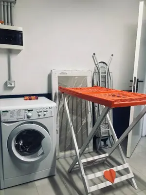 a table next to a washing machine in a kitchen at CERMIS Minisuite in Cavalese