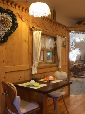 a kitchen with a table and chairs in a room at CERMIS Minisuite in Cavalese