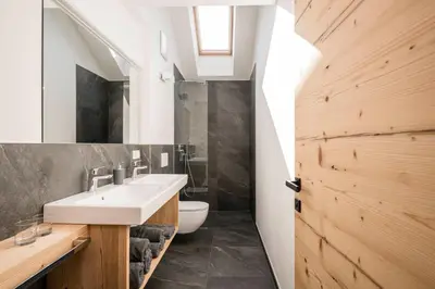 a bathroom with a sink and a toilet at Bachmannhof in Feldthurns