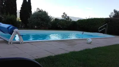 a swimming pool with a slide in a yard at Gartenheim Ferienwohnung in Caldaro