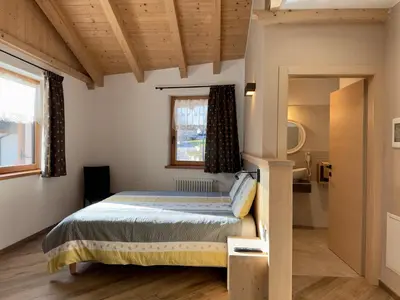 a bedroom with a bed and a window at Appartamenti LITEGOSA casa vacanza 3 in Panchia